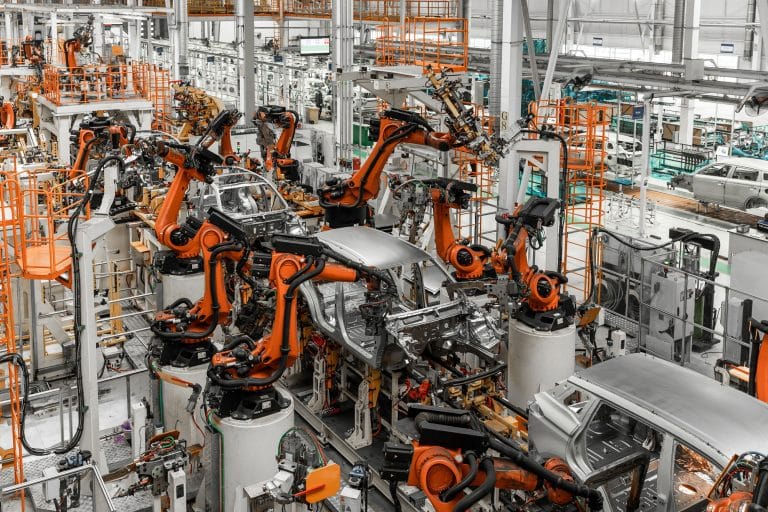 Car bodies are on assembly line. Factory for production of cars. Modern automotive industry